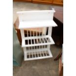 A WHITE PAINTED THREE TIER WALL RACK WITH THREE COAT HOOKS, 20" WIDE