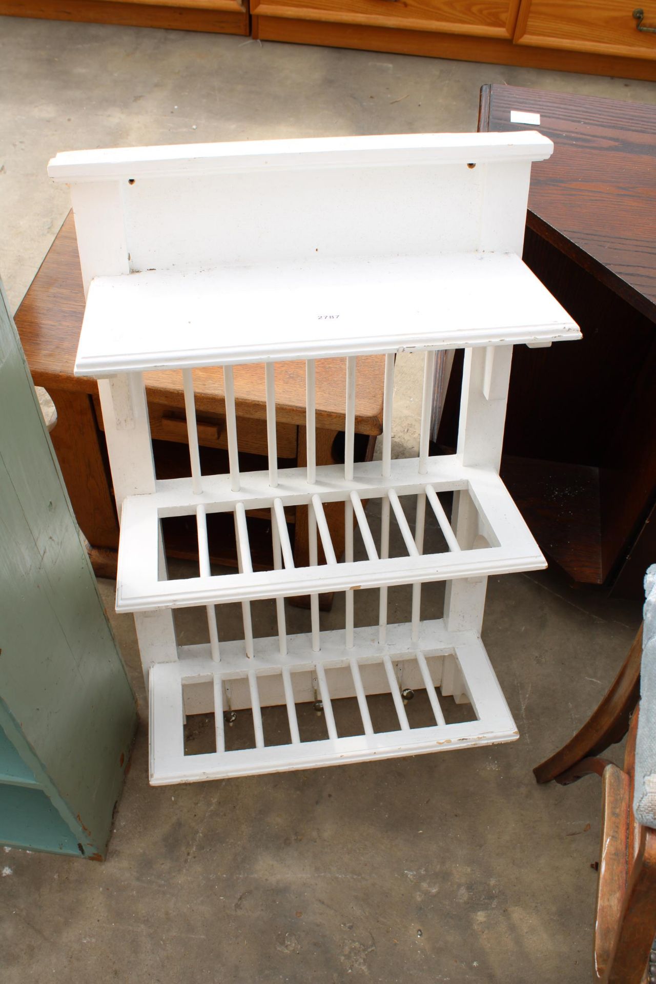 A WHITE PAINTED THREE TIER WALL RACK WITH THREE COAT HOOKS, 20" WIDE