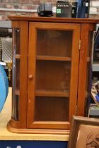 A DISPLAY CABINET WITH THREE SHELVES