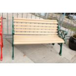 A WOODEN SLATTED GARDEN BENCH WITH DECORATIVE CAST ENDS