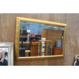 A MODERN GILT FRAMED BEVEL EDGE WALL MIRROR, 33" X 23"