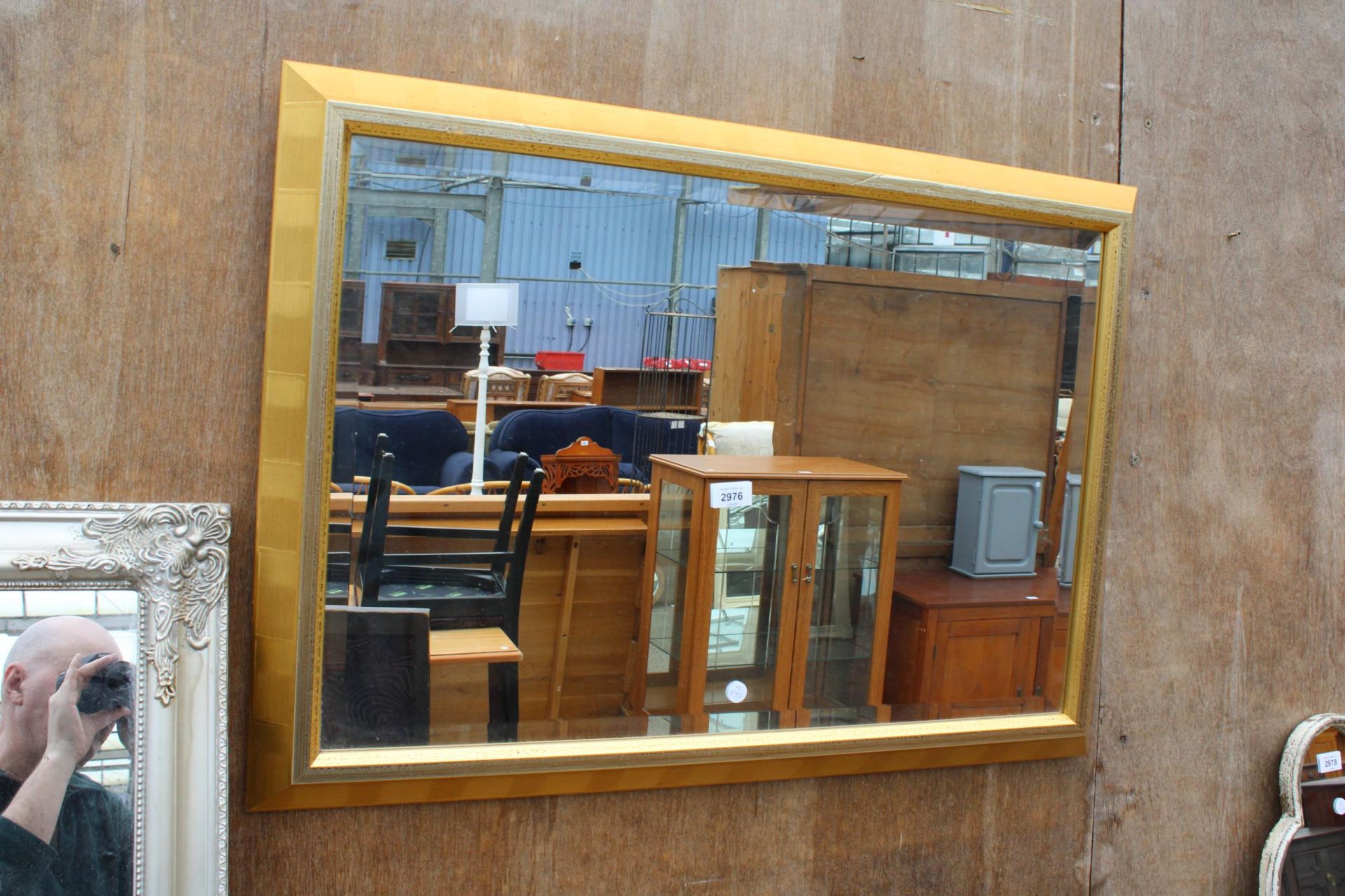 A MODERN GILT FRAMED BEVEL EDGE WALL MIRROR, 33" X 23"