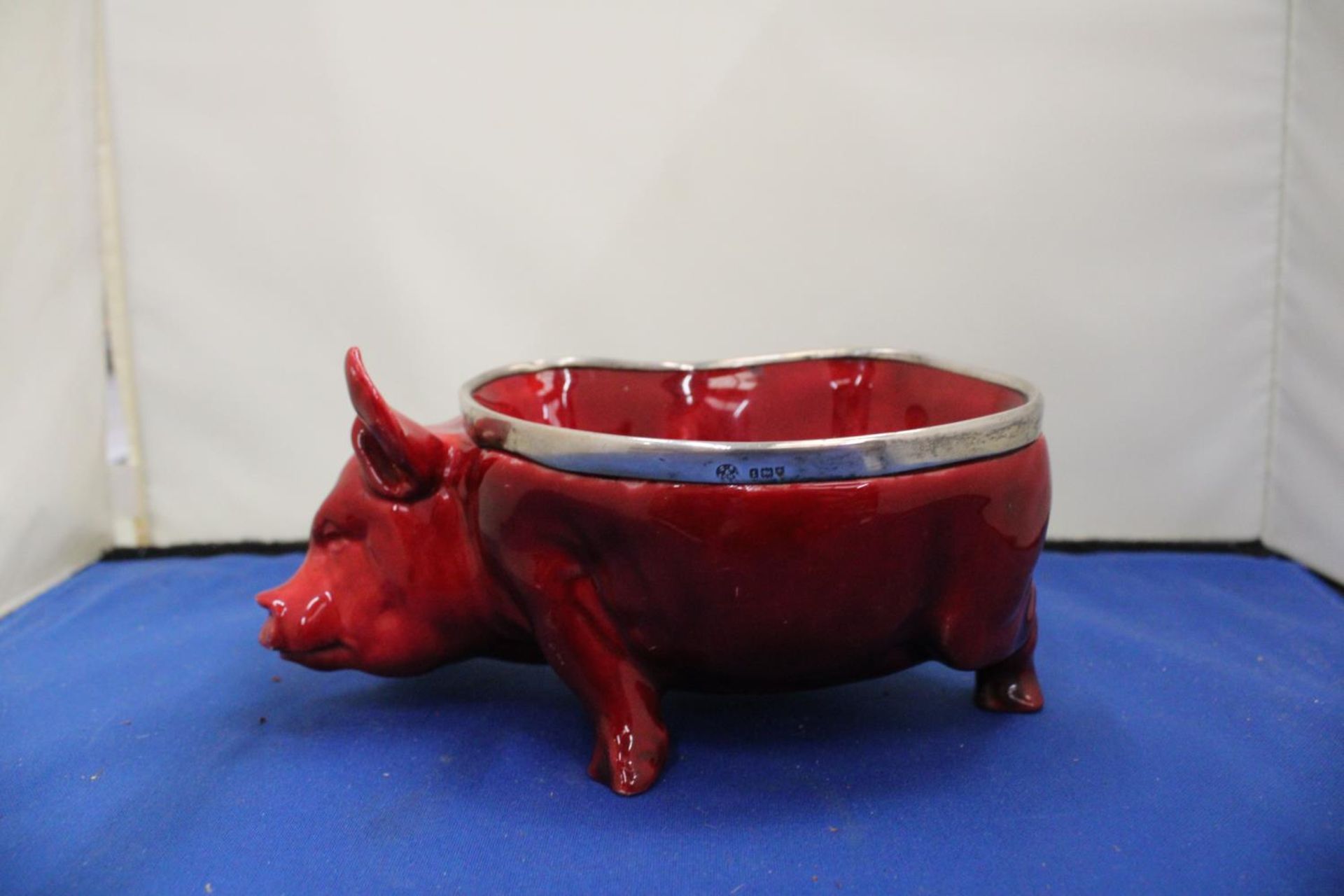 A DOULTON FLAMBE PIG WITH A HALLMARKED BIRMINGHAM SILVER RIM