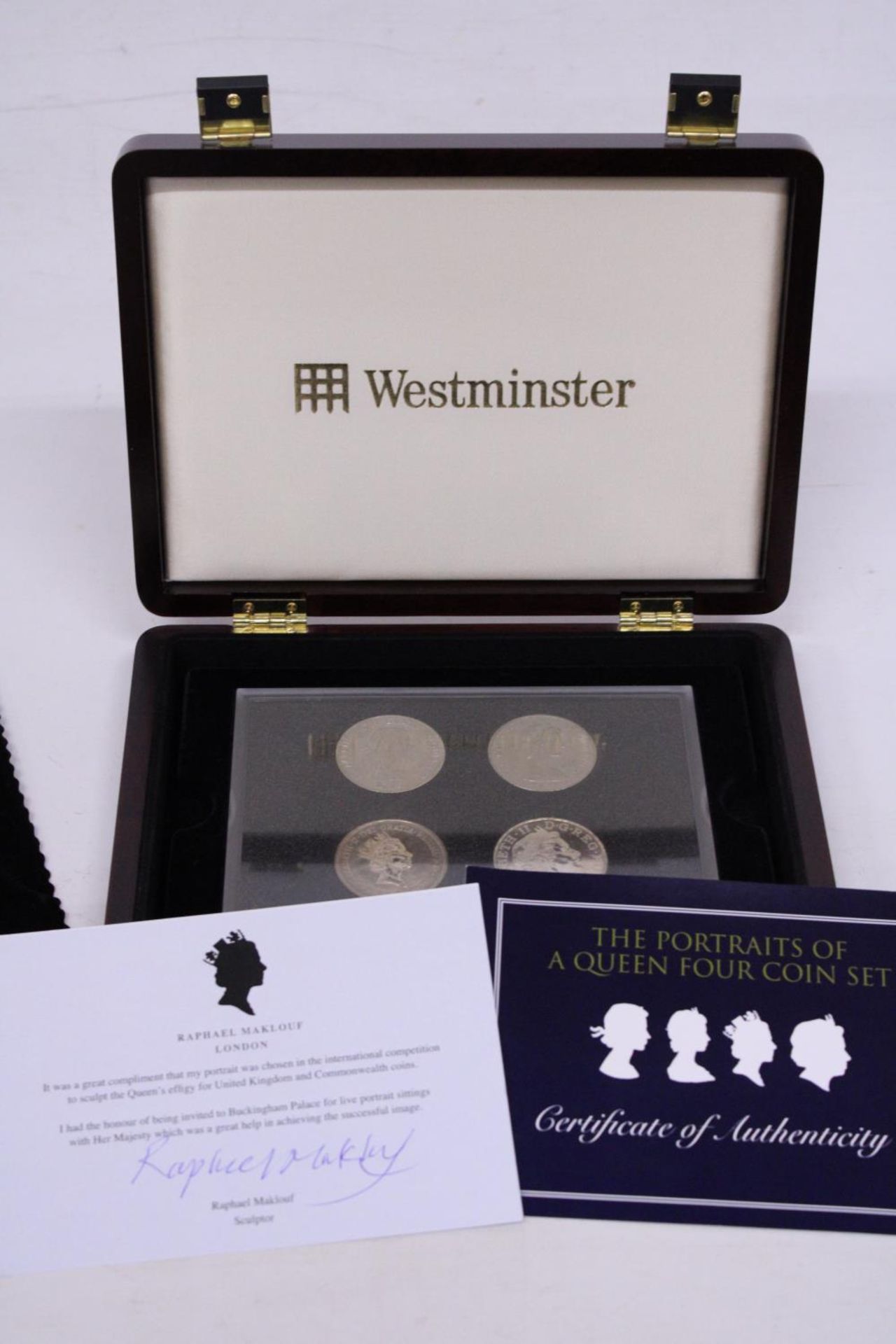 A WESTMINSTER BOXED FOUR COIN SET "THE PORTRAITS OF A QUEEN" WITH CERTIFICATE OF AUTHENTICITY