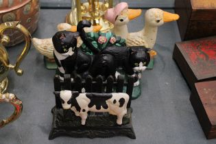 THREE CAST IRON ITEMS TO INCLUDE A LETTER RACK WITH COW DECORATION, PLUS DUCK AND CAT DOOR STOPS