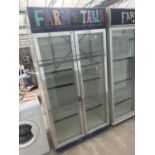 A LARGE HUSKY TWO DOOR GLASS FRONT SHOP DISPLAY FRIDGE