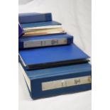 A FIVE VOLUME COLLECTION HOUSED IN BLUE BINDERS
