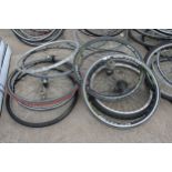 A LARGE ASSORTMENT OF VARIOUS BIKE WHEELS AND TYRES