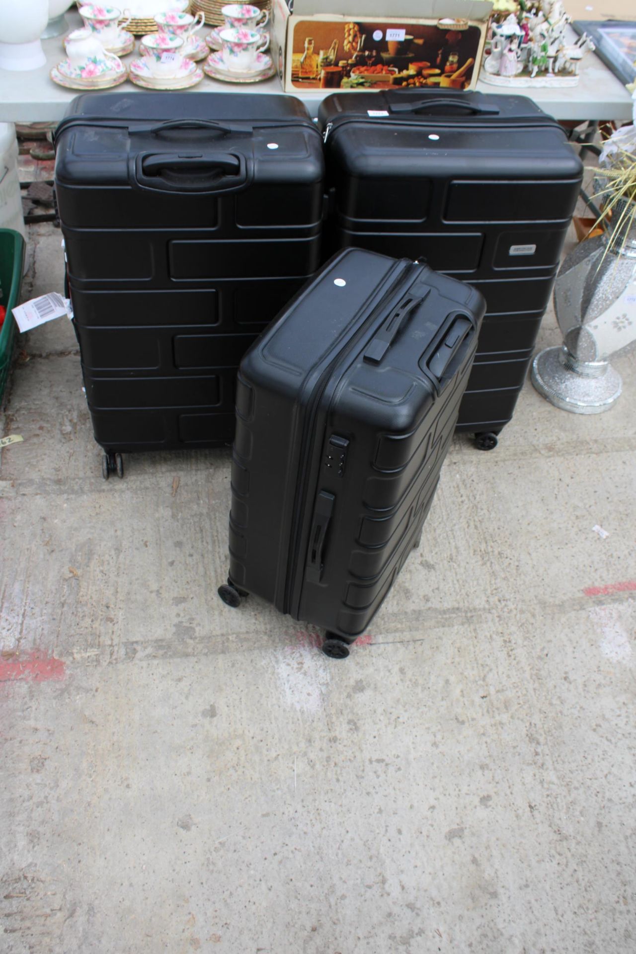 A SET OF THREE AMERICAN TOURISTER SUITCASES