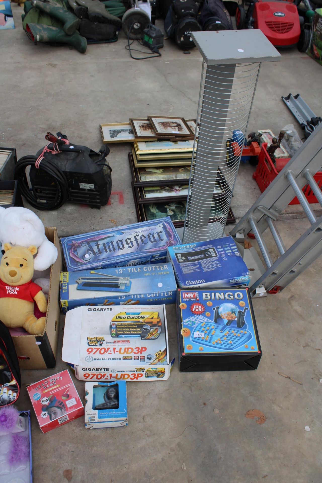 AN ASSORTMENT OF ITEMS TO INCLUDE A TILE CUTTER, A CD RACK AND BOARD GAMES ETC