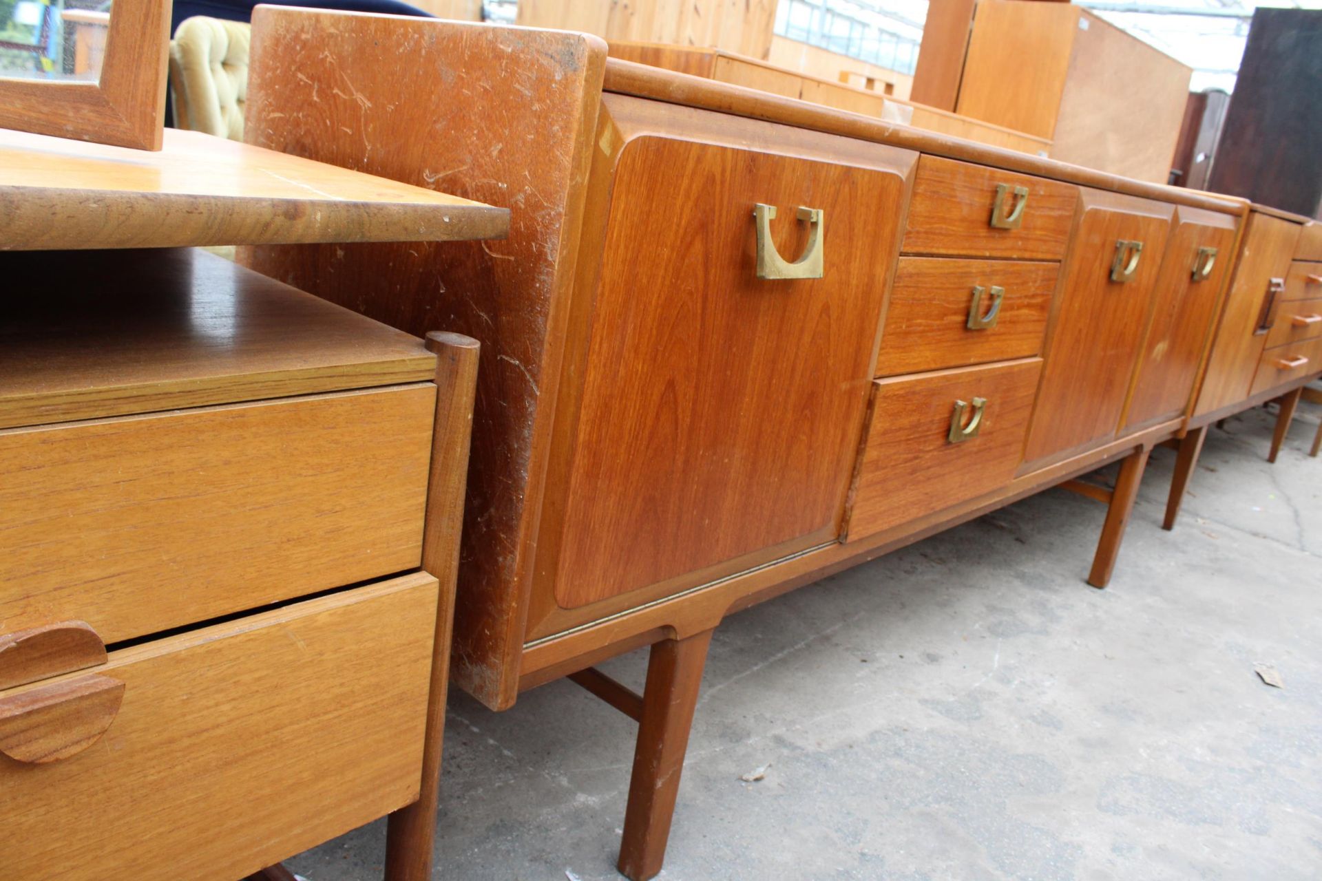 A RETRO TEAK SIDEBOARD WITH BRASS HANDLES ENCLOSING THREE DRAWERS AND THREE CUPBOARDS, 72" WIDE - Image 2 of 4