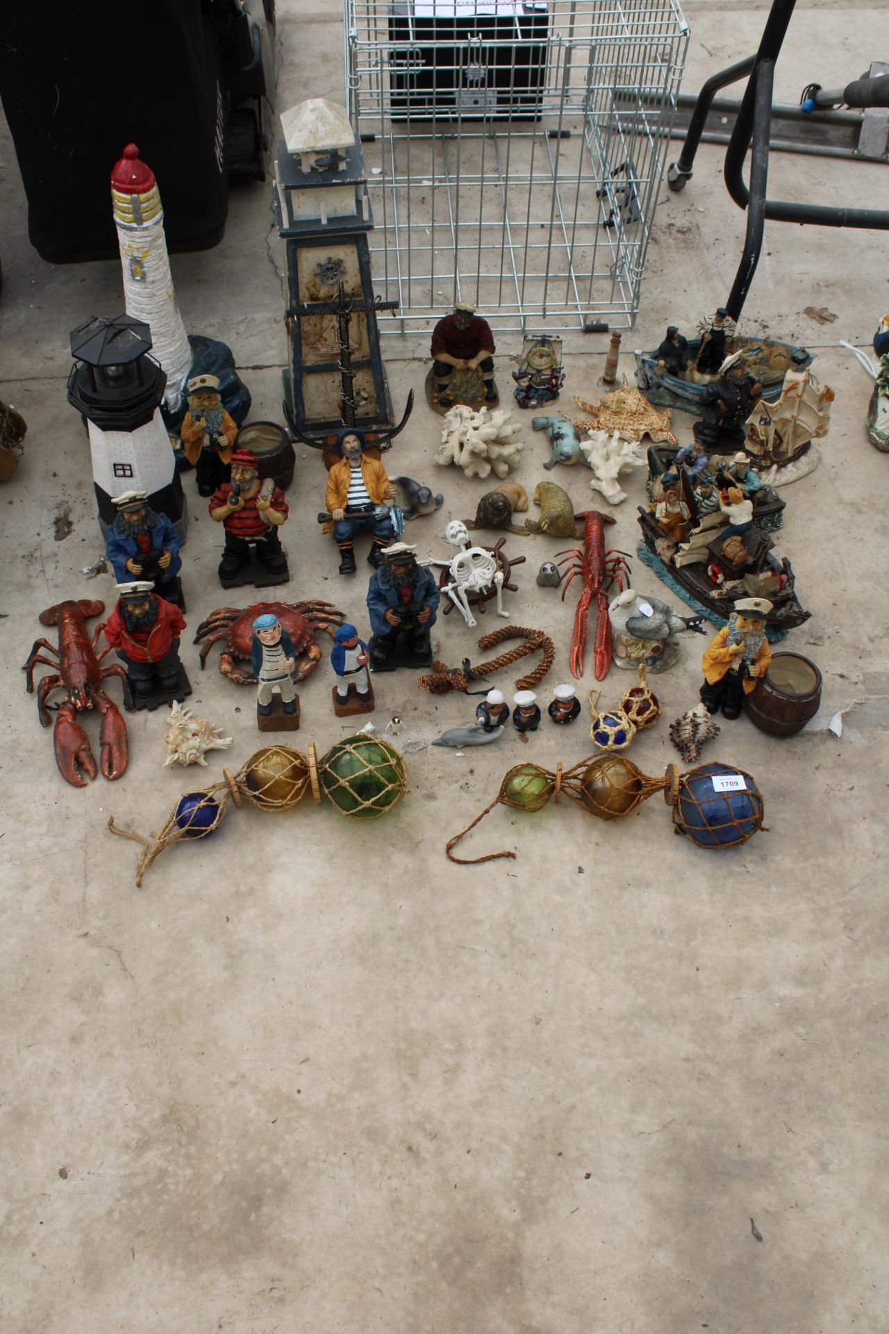 AN ASSORTMENT OF NAUTICAL RELATED ITEMS TO INCLUDE LIGHT HOUSES, SAILOR FIGURES AND ANIMALS ETC