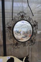 A DECORATIVE METAL FRAMED CIRCULAR MIRROR