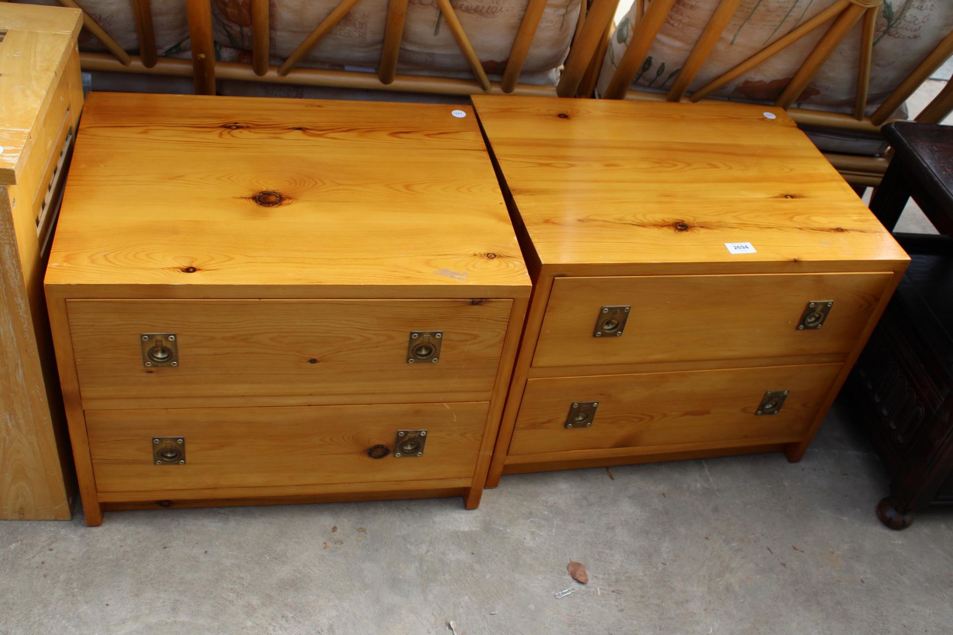 A PAIR OF MODERN PINE TWO DRAWER CHESTS WITH BRASS HANDLES