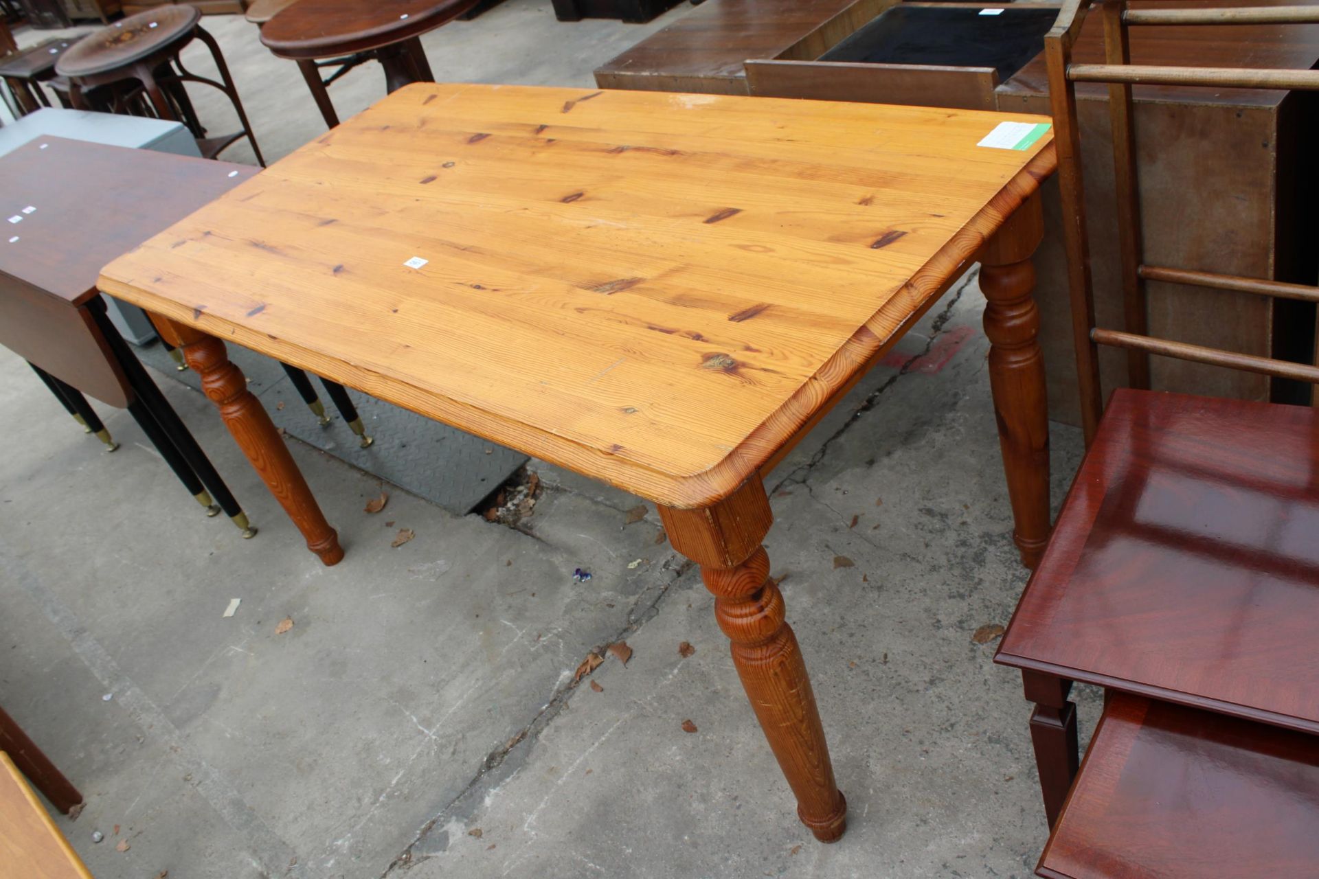 A PINE KITCHEN TABLE ON TURNED LEGS 59" X 31"