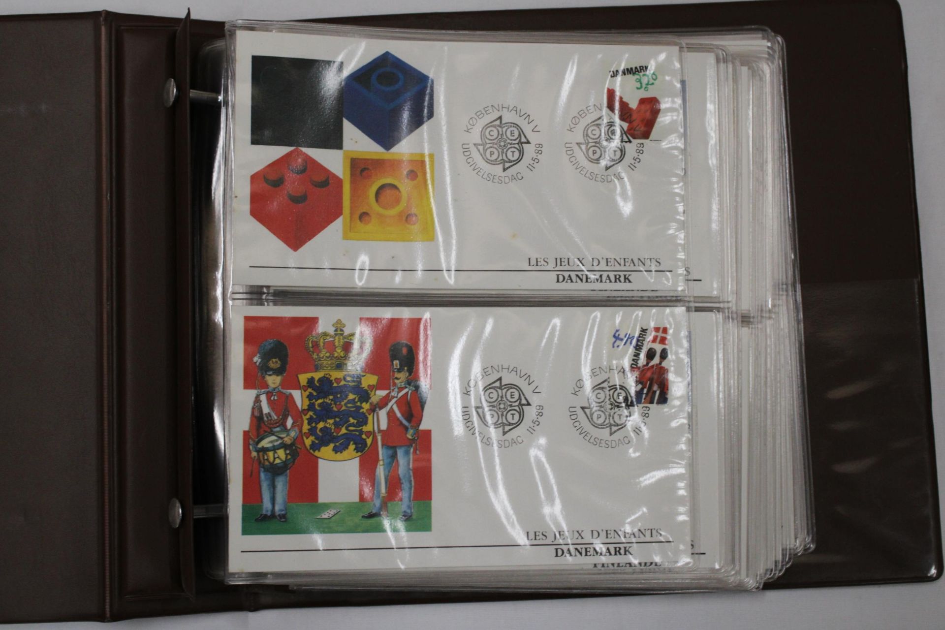 A FULL ALBUM OF FIRST DAY COVERS TO INCLUDE JERSEY LES JEUX D'ENFANTS, SAINT MARIN, 30TH ANNIVERSARY