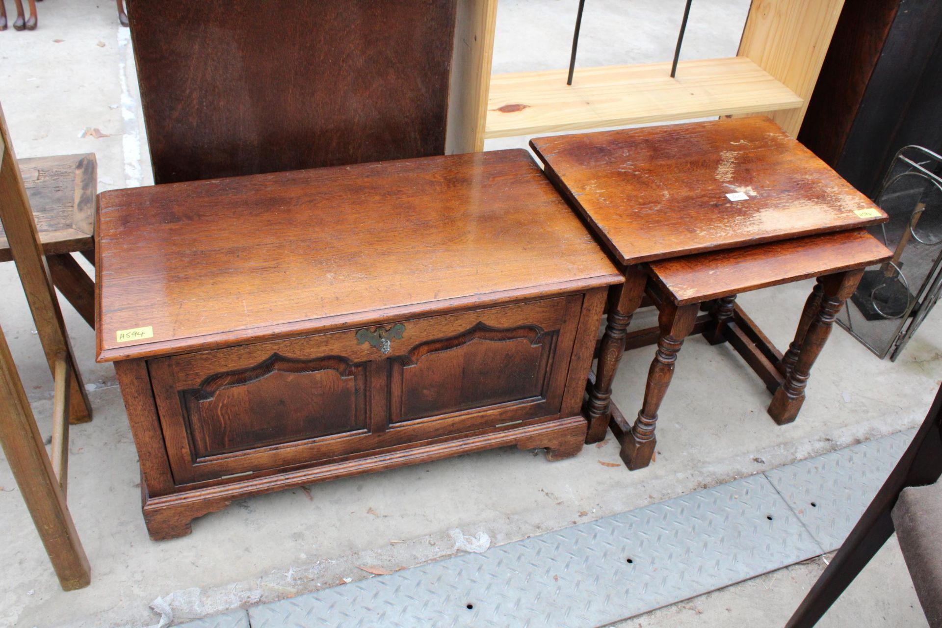 A MODERN OAK NEST OF TWO TABLES AND AN OAK ANTIQUE STYLE CABINET