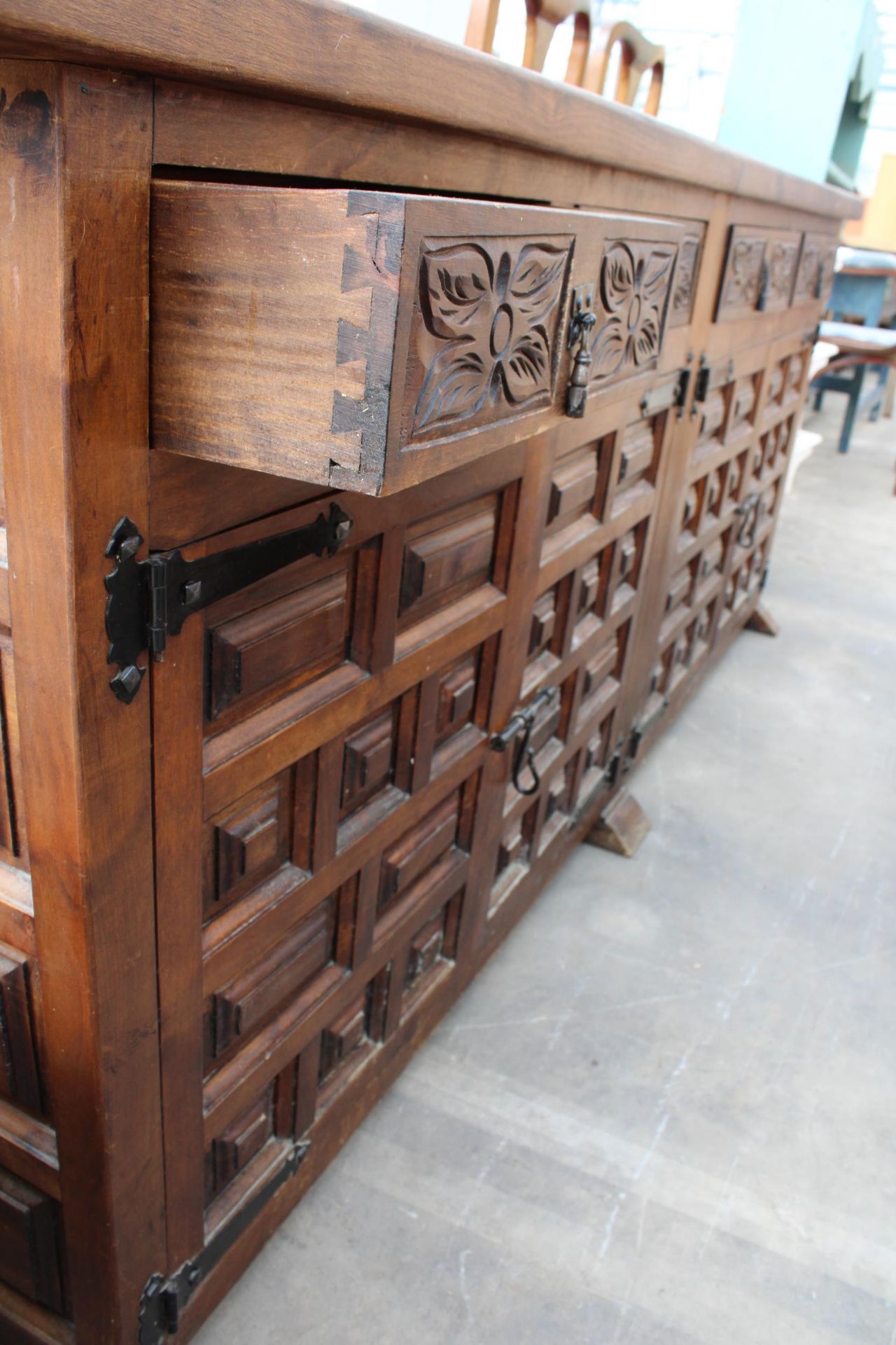 A MODERN SPANISH STYLE HARDWOOD SIDEBOARD WITH RAISED PANEL DOORS AND CARVED DRAWERS, 77" WIDE - Image 4 of 5