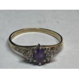 A 9 CARAT GOLD RING WITH A CENTRE AMETHYST SURROUNDED BY CUBIC ZIRCONIAS SIZE Q/R