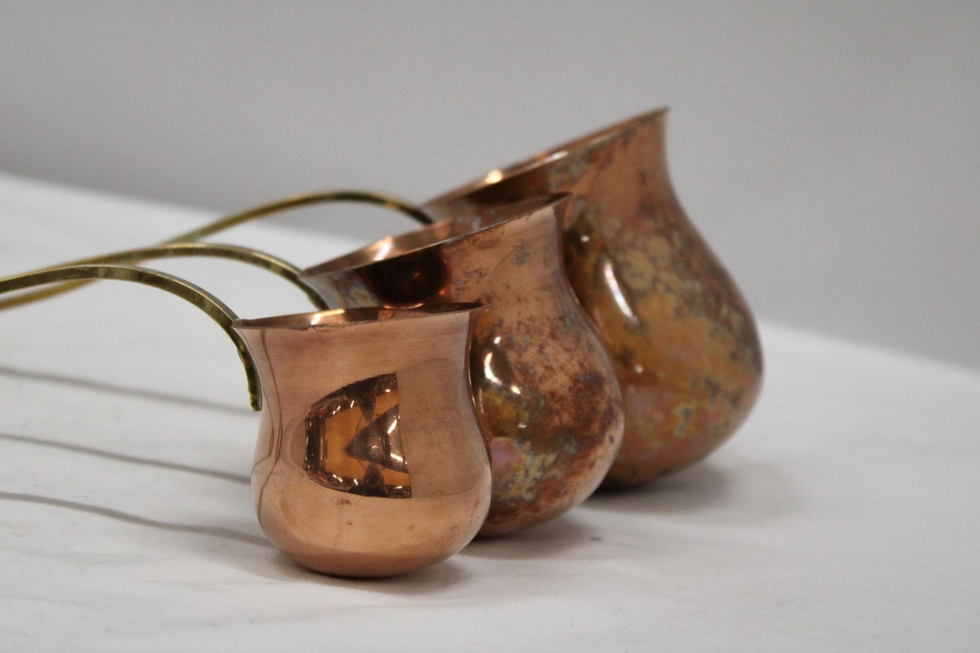 THREE VINTAGE COPPER AND BRASS MEASURING LADELS, RUM, WHISKY AND BRANDY - Image 5 of 5