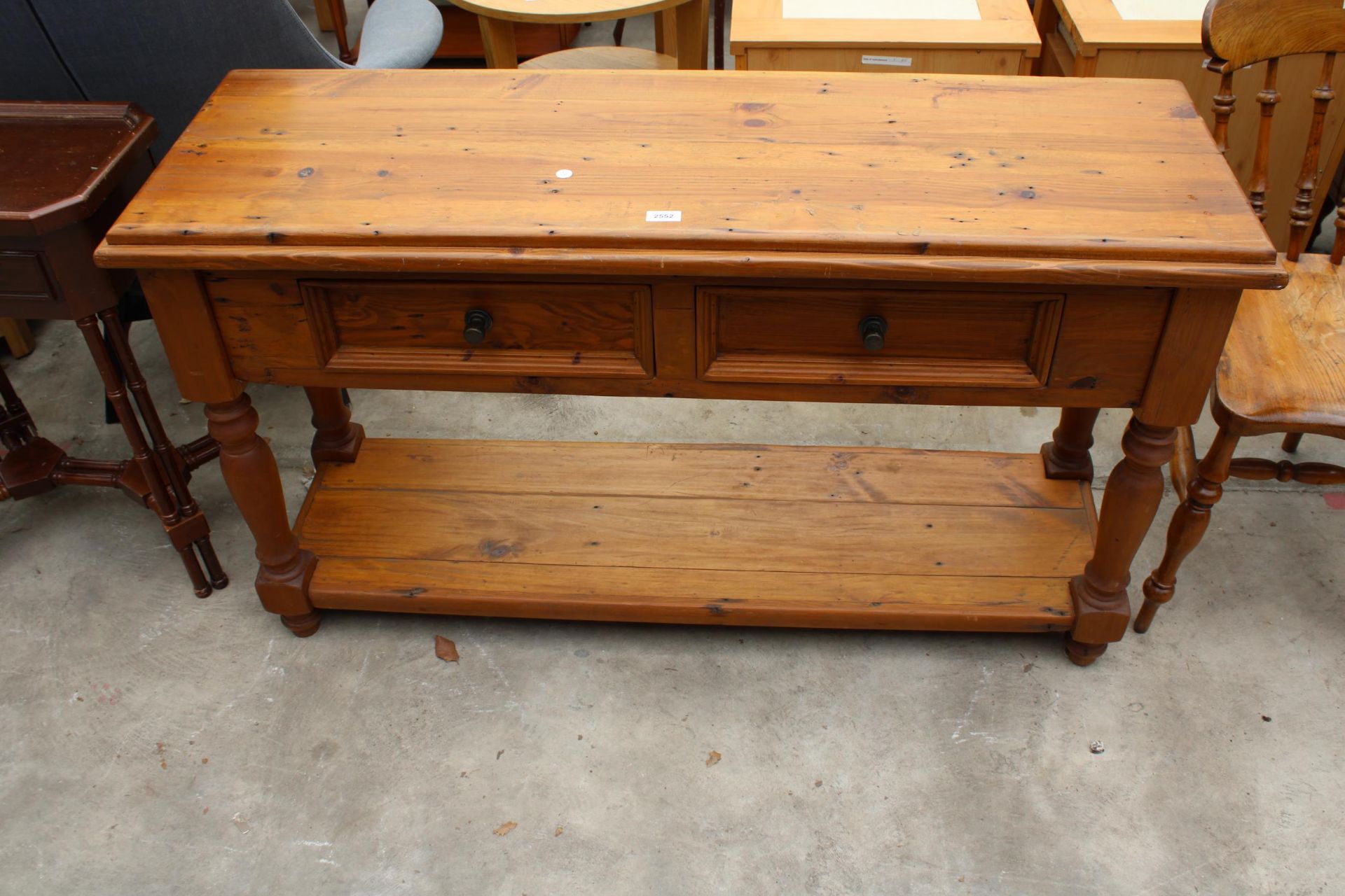 A PINE SIDE TABLE WITH TWO FRIEZE DRAWERS AND POT BOARD 52" WIDE