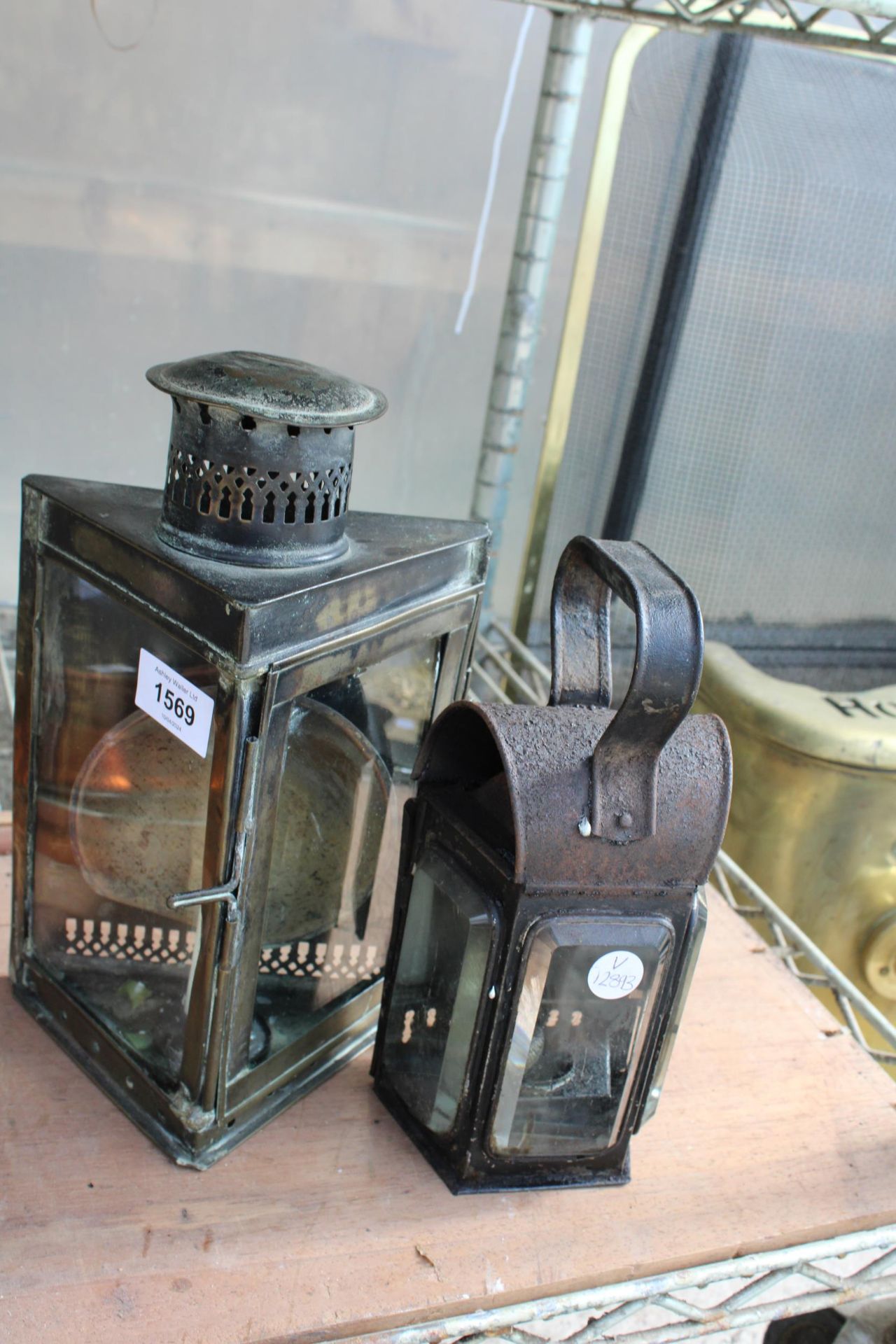 A VINTAGE PARAFIN LANTERN AND A FURTHER CANDLE LANTERN