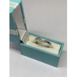 A SILVER RING IN A PRESENTATION BOX