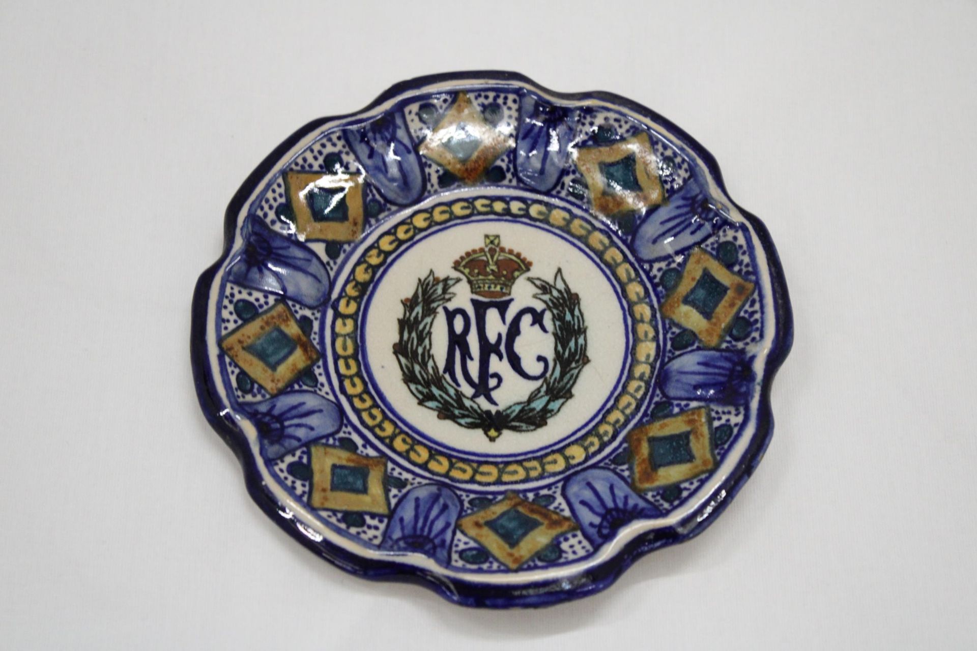 A VINTAGE CONTINENTAL SMALL PLATE WITH THE LOGO FOR THE ROYAL FLYING CORPS