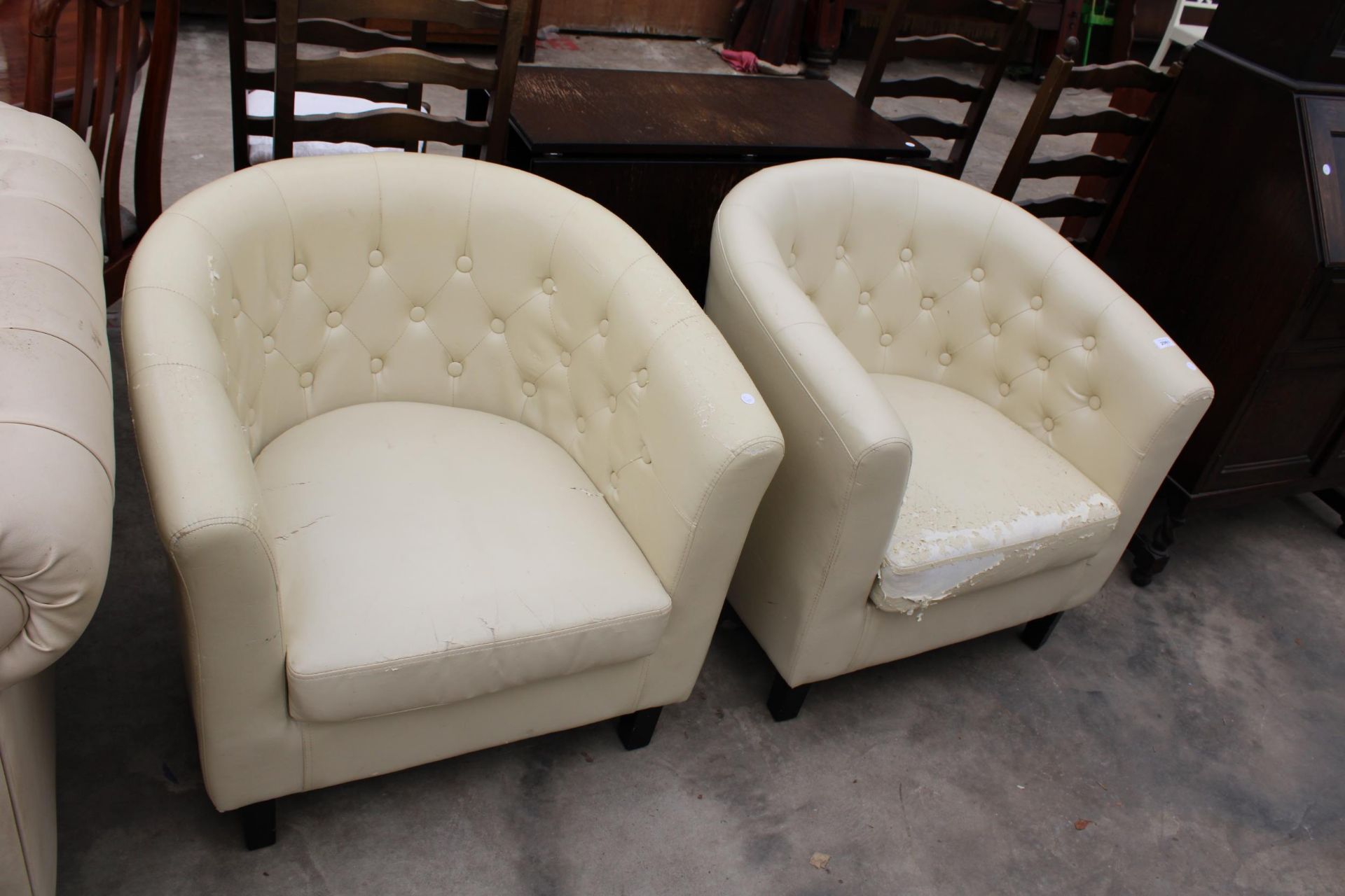 A PAIR OF MODERN CREAM FAUX LEATHER TUB CHAIRS