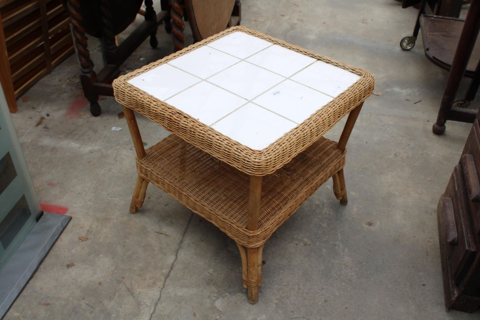 A TWO TIER WICKER LAMP TABLE WITH TILED TOP AND A GLASS FRONTED TWO DOOR BOOKCASE