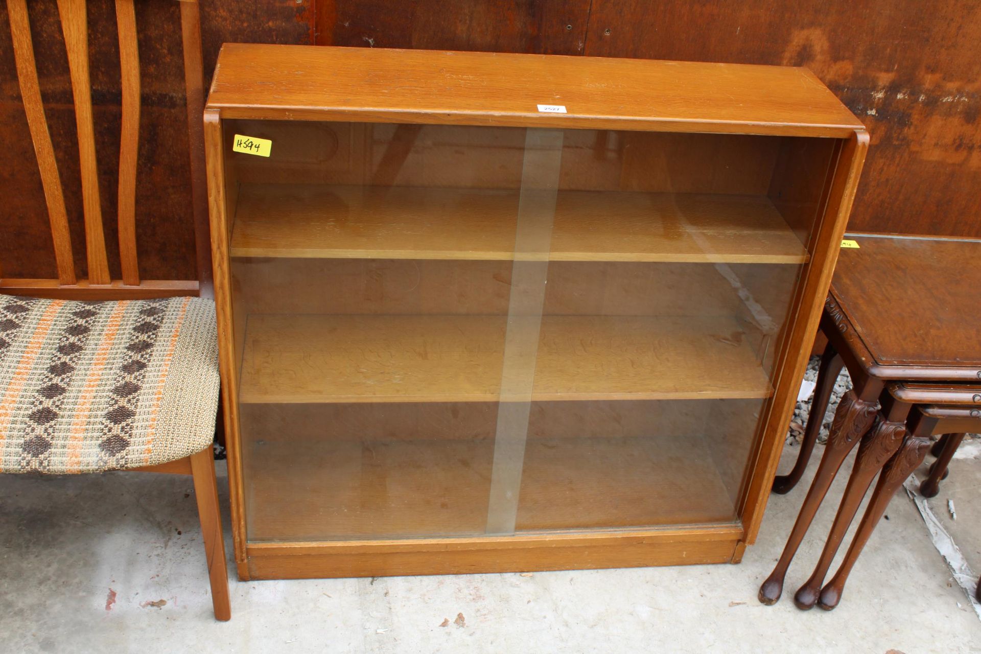 A RETRO OAK BOOKCASE WITH TWO SLIDING DOORS 36" WIDE