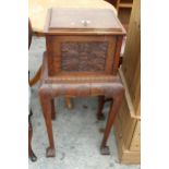 A VICTORIAN OAK CABINET ON STAND WITH CARVED FLORAL PANELS ON CABRIOLE LEGS WITH CLAW FEET