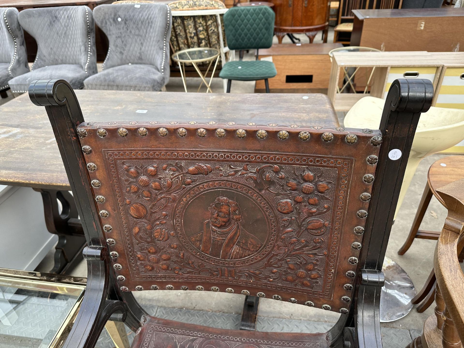 A VICTORIAN CROSS FRAMED ELBOW CHAIR WITH EMBOSSED LEATHER BACK AND SEAT - Bild 2 aus 4