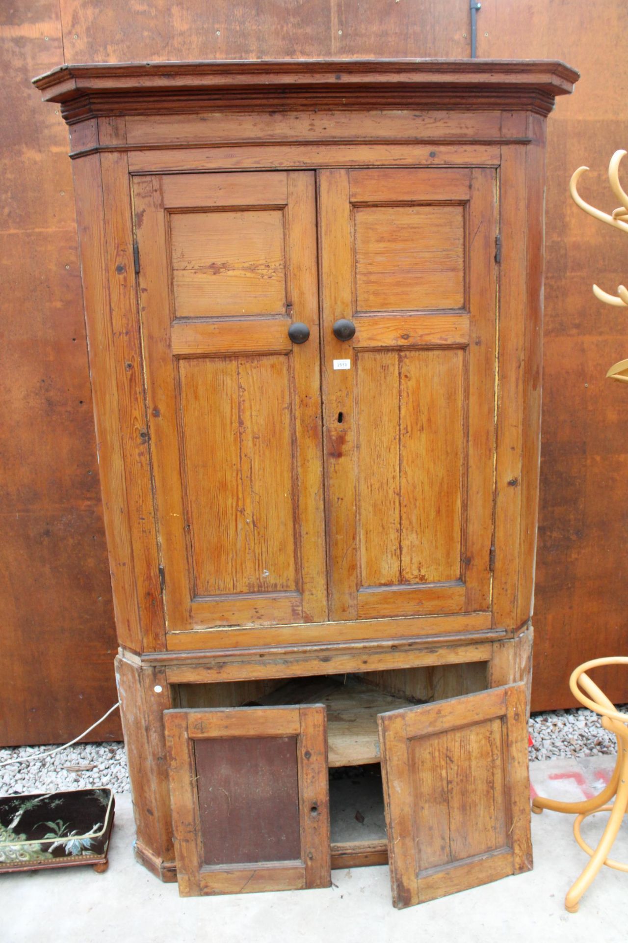 A 19TH CENTURY PINE FULL LENGTH FOUR DOOR CORNER CUPBOARD WITH SHAPED INTERIOR SHELVES TO UPPER