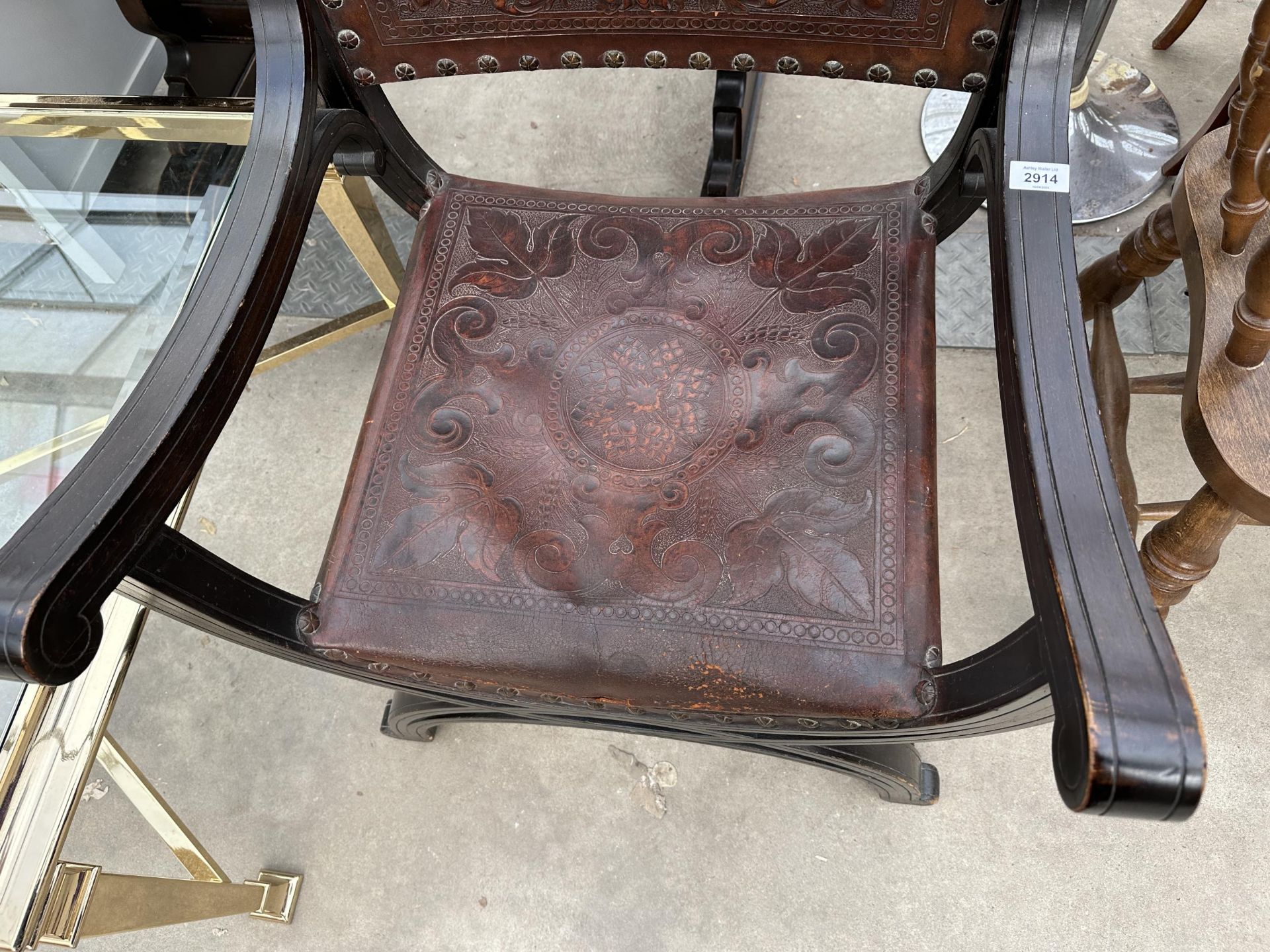 A VICTORIAN CROSS FRAMED ELBOW CHAIR WITH EMBOSSED LEATHER BACK AND SEAT - Image 3 of 4