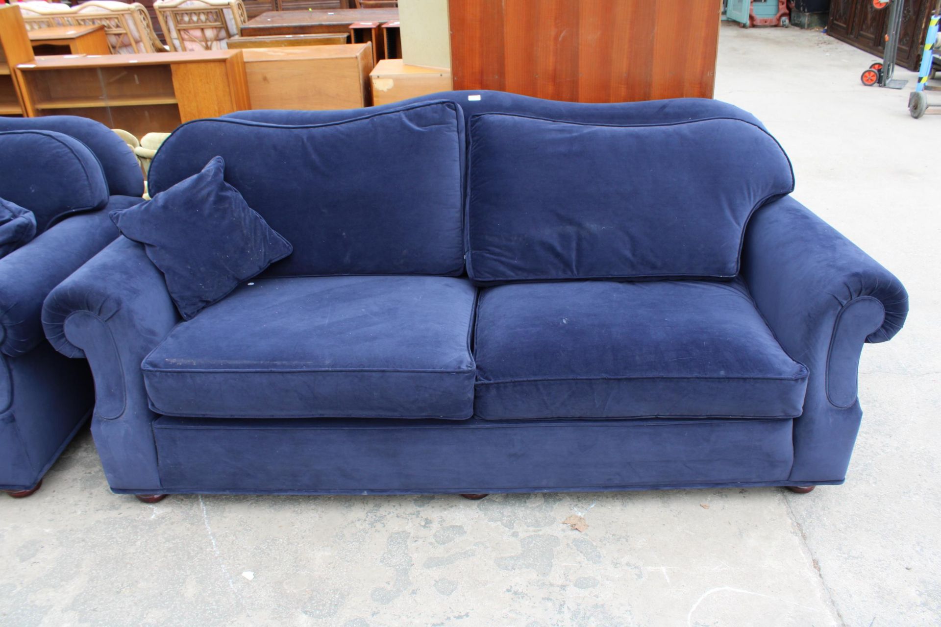 A MODERN BLUE THREE SEATER SETTEE WITH SPRUNG EDGE