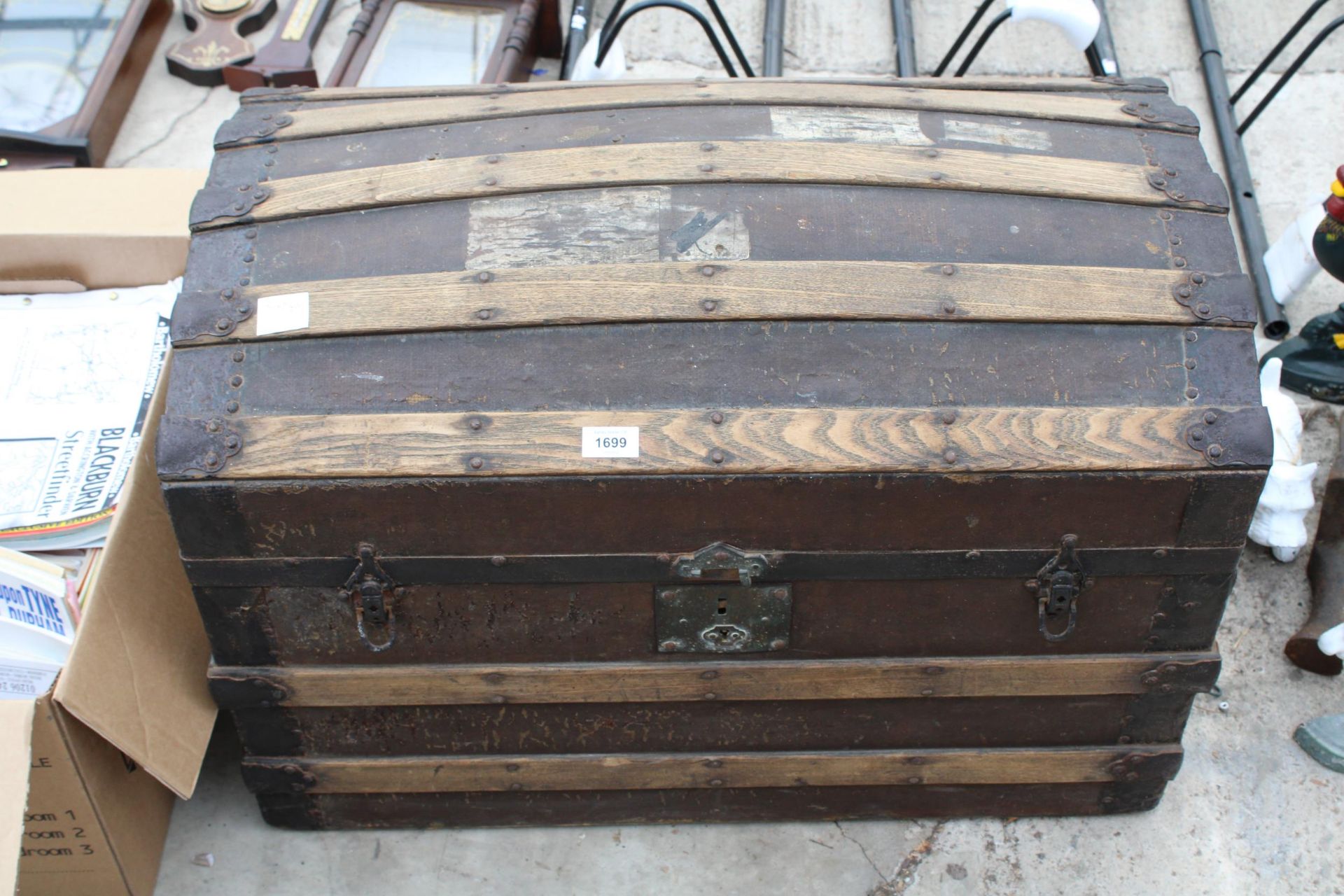 A VINTAGE WOODEN BANDED DOME TOPPED TRUNK