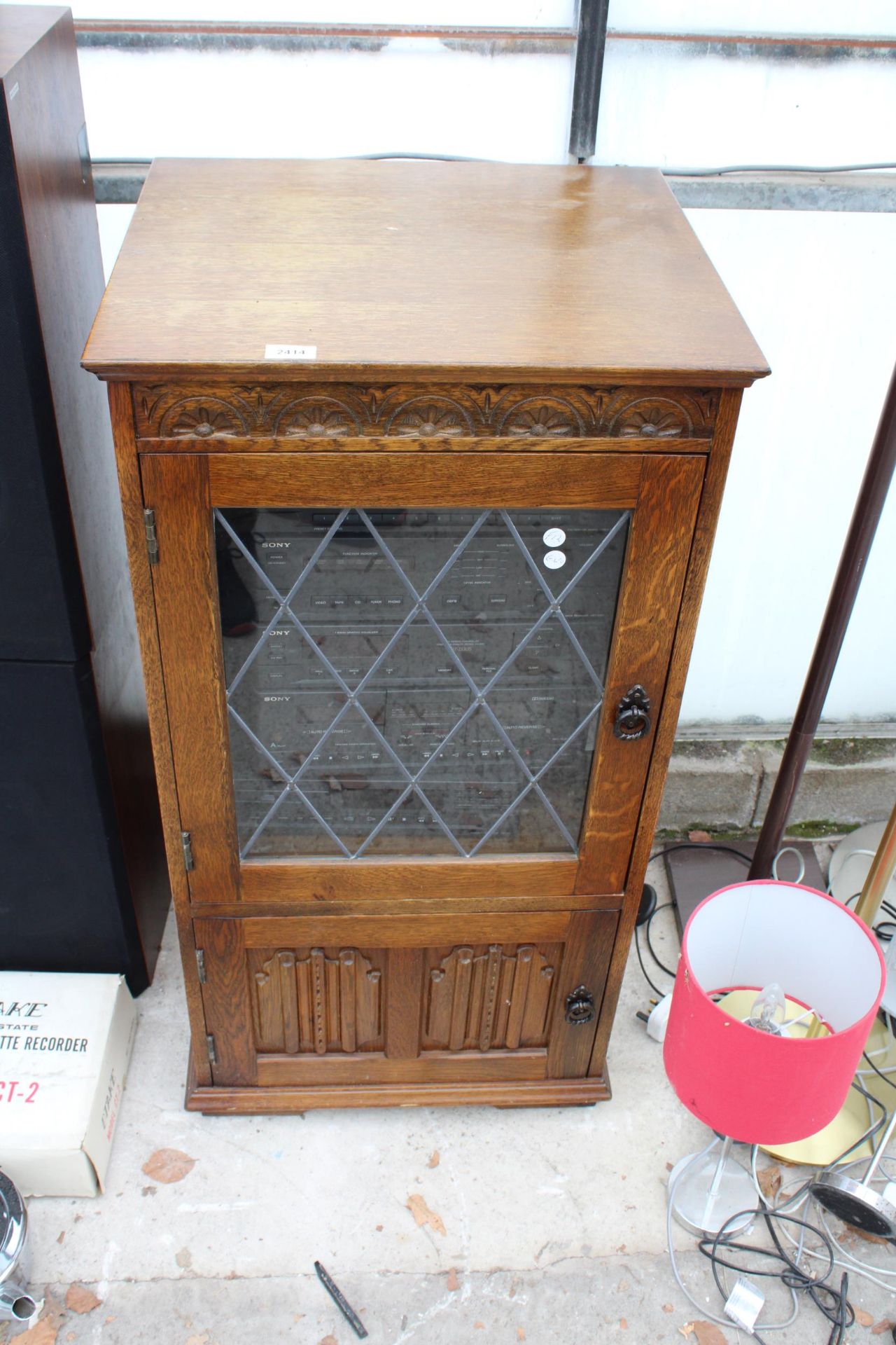 AN OAK RECORD CABINET CONTAINING A SONY COMPACT HI-FI STEREO SYSTEM