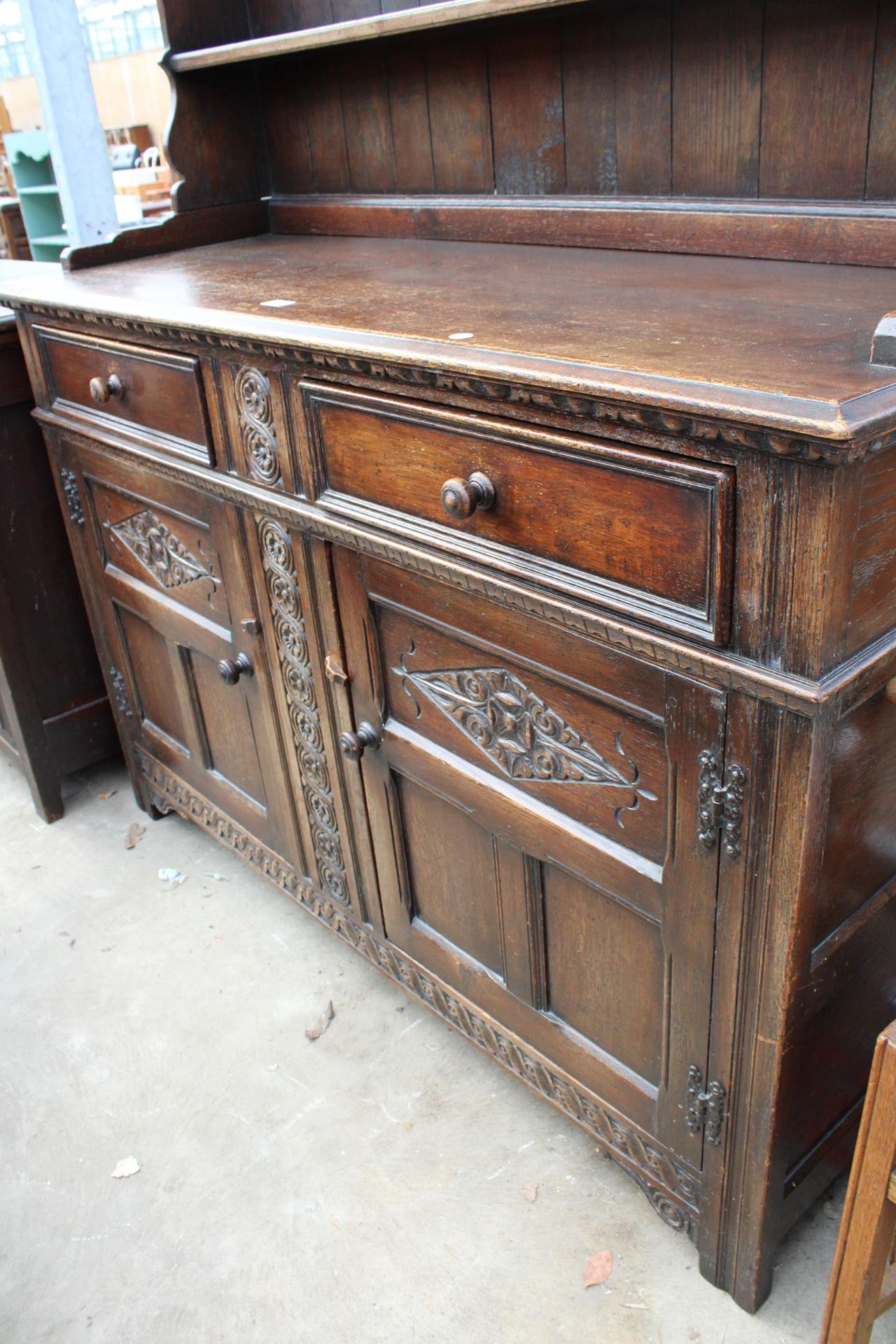 AN OAK JACOBEAN STYLE DRESSER WITH CARVED PANELS AND PLATE RACK, 56" WIDE - Image 3 of 5