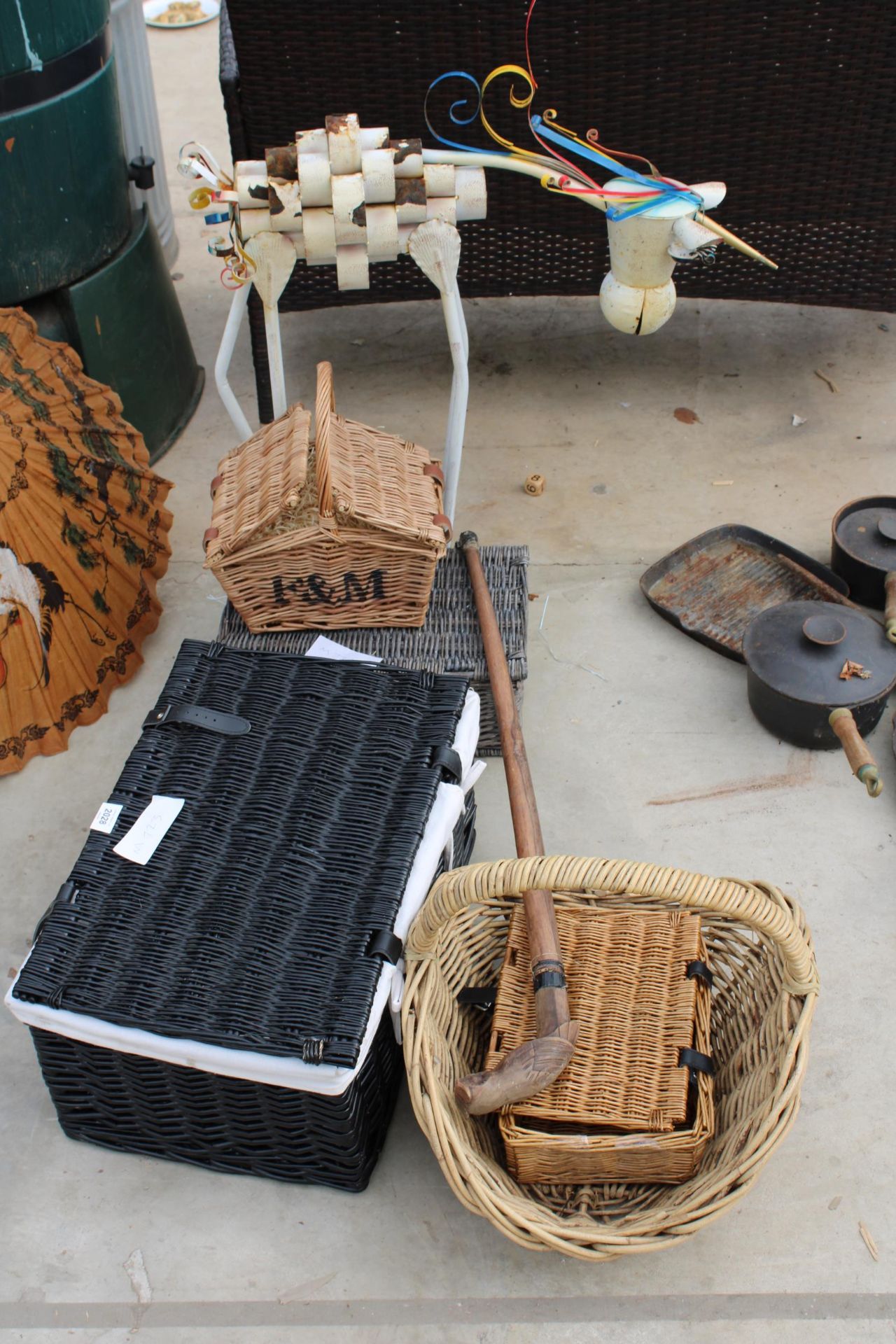 AN ASSORTMENT OF ITEMS TO INCLUDE WICKER BASKETS, A WALKING STICK AND A METAL FIGURE