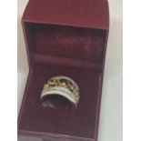 A GOLD ON SILVER ELEPHANT RING IN A PRESENTATION BOX