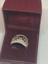 A GOLD ON SILVER ELEPHANT RING IN A PRESENTATION BOX