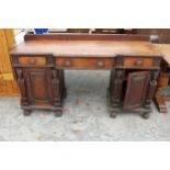A VICTORIAN OAK BREAKFRONT SIDEBOARD ON CARVED CLAW FEET WITH CARVED PANELS WITH MYTHICAL