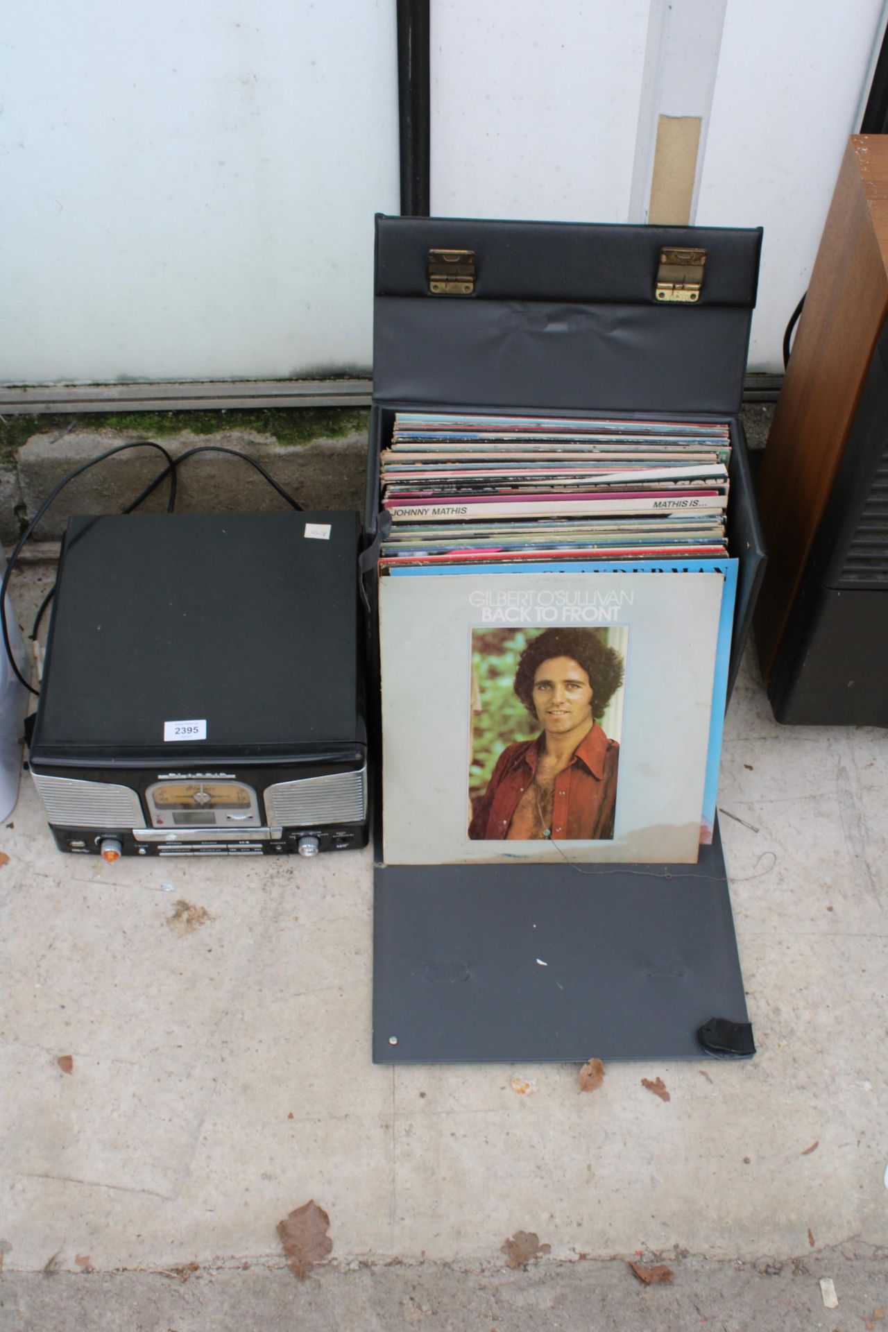 A PORTABLE RECORD PLAYER AND AN ASSORTMENT OF LP RECORDS