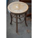 A BENTWOOD STOOL WITH SPLIT CANE SEAT