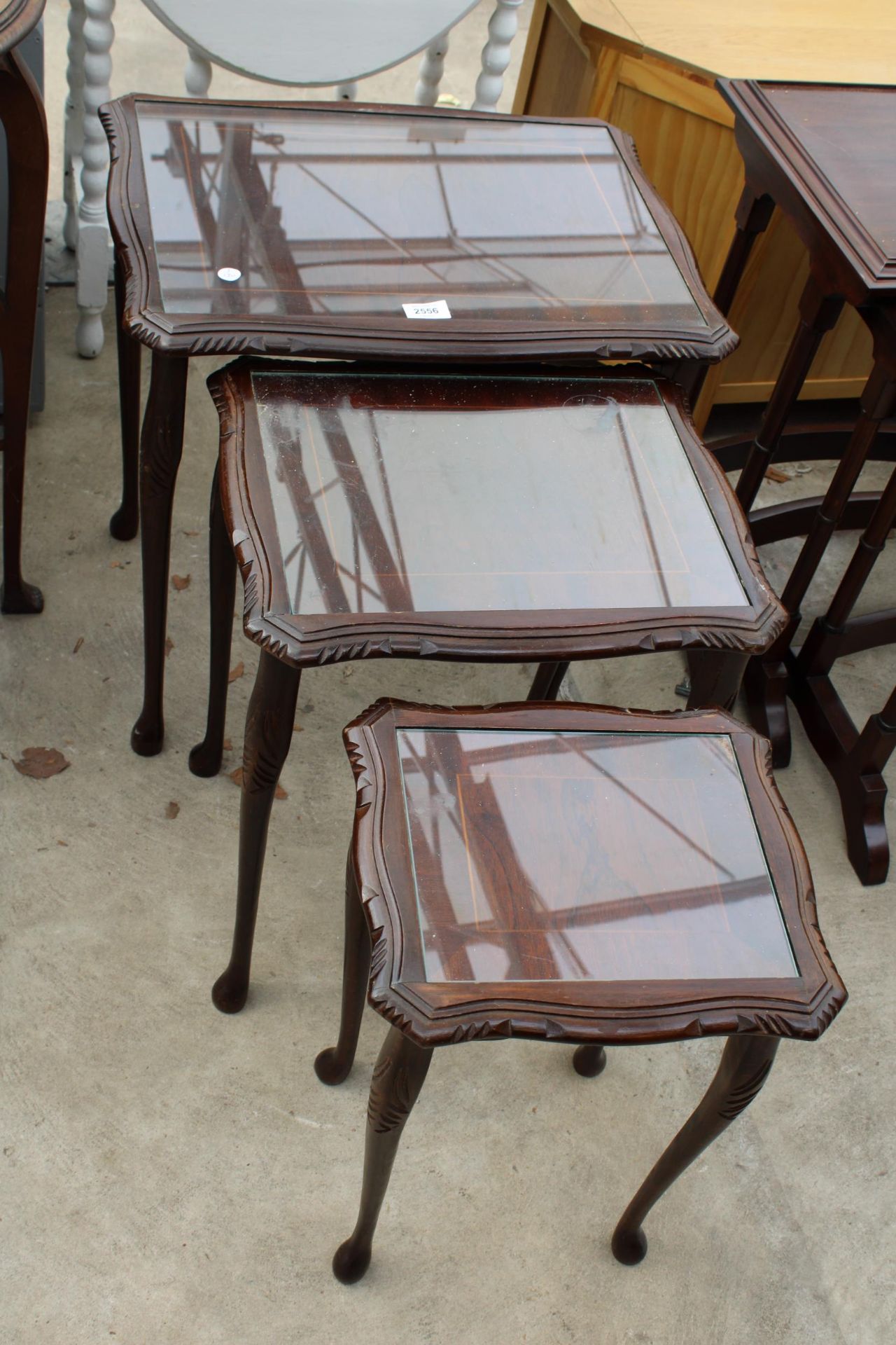 A MAHOGANY NEST OF THREE TABLES ON CABRIOLE LEGS - Image 2 of 2