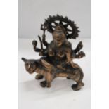 A BRONZE EXOTIC INDIAN MOTHER GODDESS ON A TIGER'S BACK, HEIGHT 38CM, LENGTH 28CM