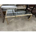 A MODERN POLISHED BRASS COFFEE TABLE WITH GLASS TOP AND TAPERING LEGS, 48" X 32"