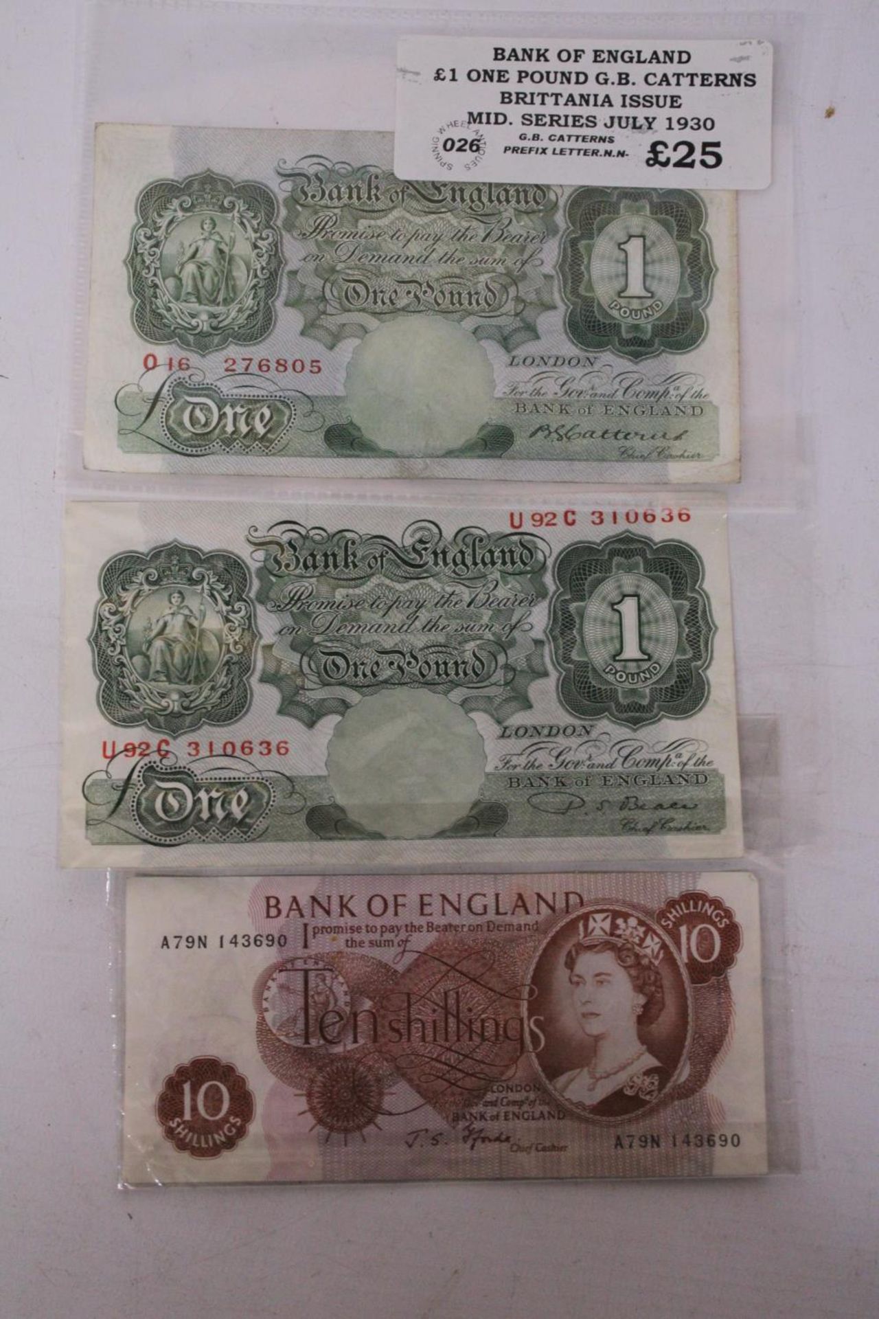 TWO ONE POUND NOTES AND A TEN SHILLING NOTE