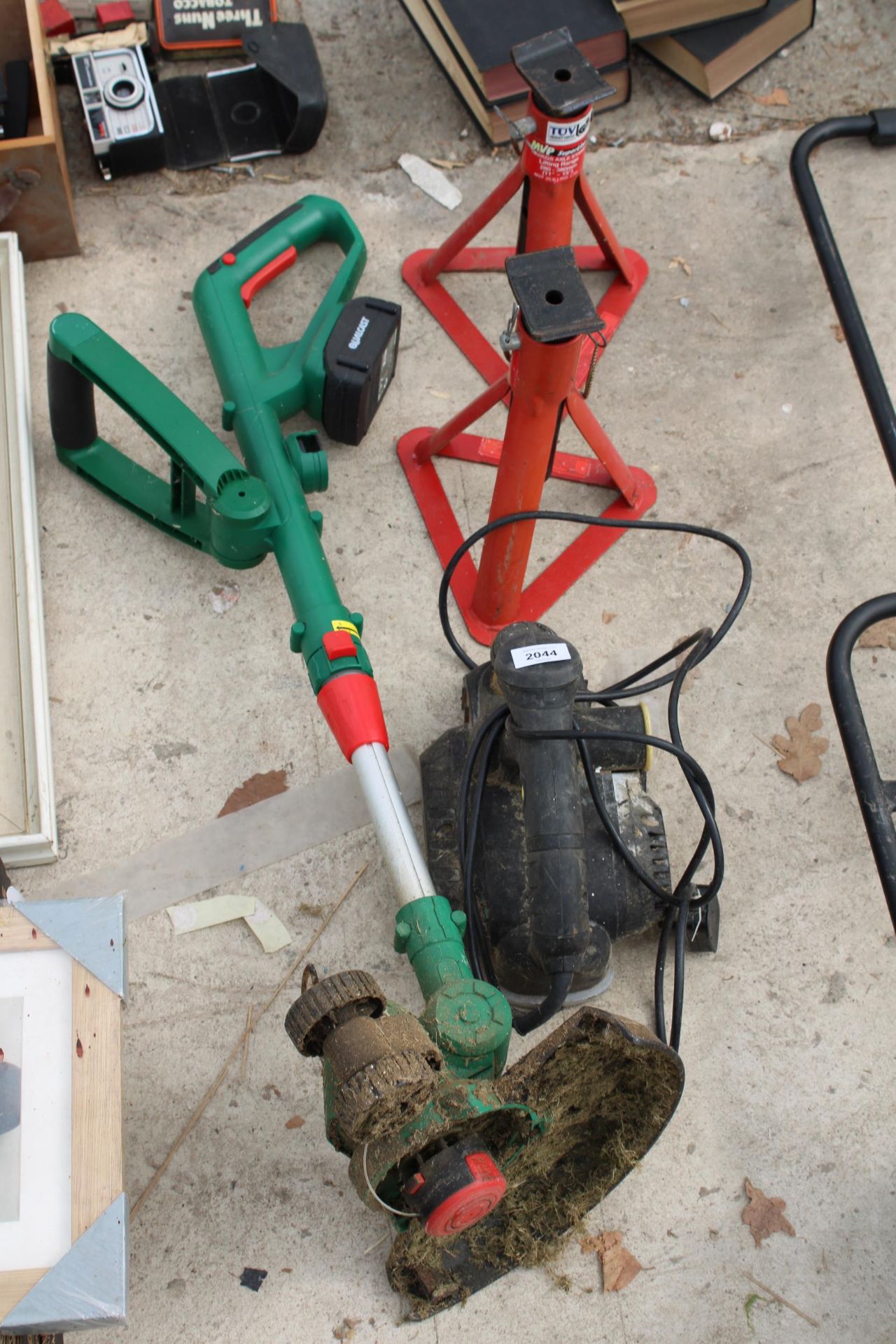 AN ELECTRIC WOOD PLANE, A PAIR OF AXLE STANDS AND A QUALCAST BATTERY POWERED STRIMMER